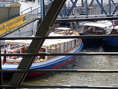 Barge with men behind bridge