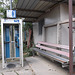 Phone booth and long rustic bench / Banc rustique et cabine téléphonique.