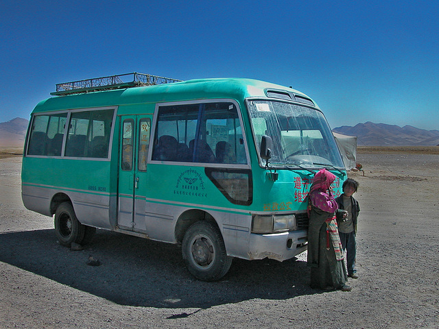 Tibetan kids in front of an overland bus