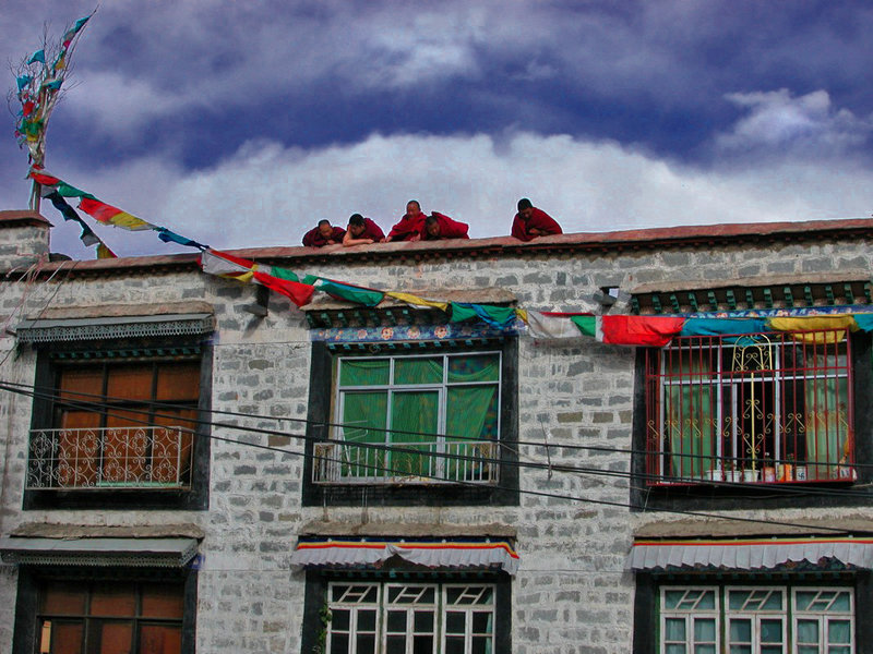 Monks on a rooftop in the Tibetan quarter of Lhasa