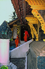 Monks come out the Sim of Wat Xieng Thong