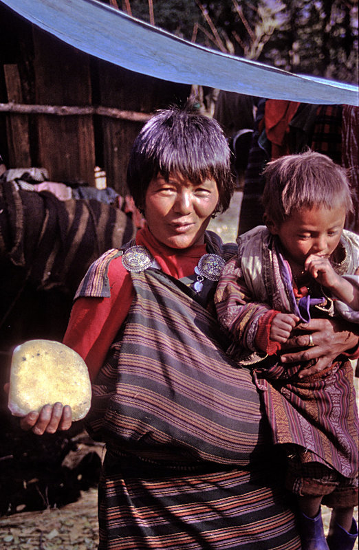 Bhutanese herds woman selling cheese