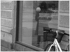 Arkitekter readhead Lady in sexy boots -  Copenhagen  /   October 20th 2008. - Window store reflection. B & W.