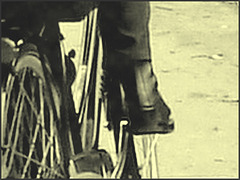 Cycliste Danoise  mature en bottes modérément sexy  - Mature Danish biker in chunky heeled leather boots- Cimetière de Copenhague- Photo ancienne avec photofiltre. Vintage style with phofilter.