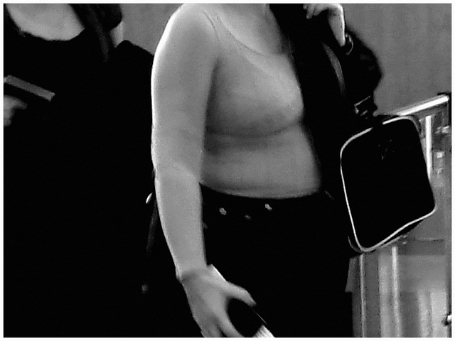 Poitrine mature et volumineuse - Mature with big solid boobs - PET Montreal airport. - Photofiltered in black & white.