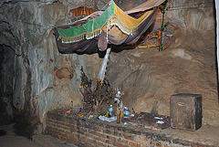 A sacrificial altar and a donation box in the cave