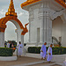 Nuns pass the door to the Golden Stupa