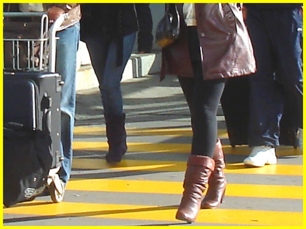 High heeled Boots and tights on yellow lines -  Bottes à talons hauts et collants sur lignes jaunes- Aéroport de Montréal.