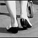 Blond mature in white sexy strappy sandals-  Dame blonde du bel âge en sandales blanches à courroies -  Aéroport de Montréal- Photofiltre en noir & blanc.