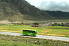 Modern tourist bus runs beside the Tibet train