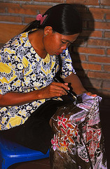 Balinese woman drawing Batik art with a canting needle