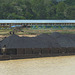 Coal Barge Passing Modern Longhouse