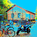 Aire de stationnement pour vélos et scooters /  Train station: Bikes and scooters parking  - Båstad,  Sweden / Suède.  - 20-10-08  - Couleurs ravivées + ciel bleu ajouté et postérisation