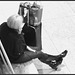 Croisé de bottes et cellulaire / Cell phone and crossed boots -  Aéroport de Montréal /  Montreal airport -  15 Novembre 2008. - N & B