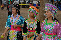 Three Hmong girls in different costumes
