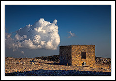a cloud and a stone hut