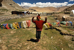 Tibetan nomad boy with prayer flags