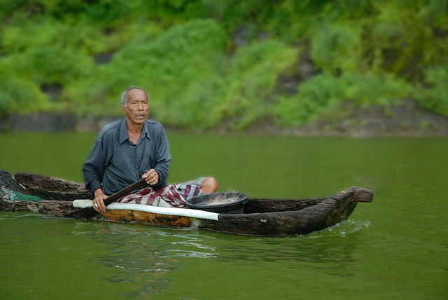 Fisherman goes out in a dugout canoe