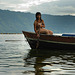 Young girl rowing her fishing boat