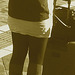 La jeune Dame SkaneExpressen en jupe courte et bottes à talons plats / SkaneExpressen pony tail Lady in short skirt and sexy flat boots  Ängelholm / Suède- Sweden .  23-10-2008 - Sepia