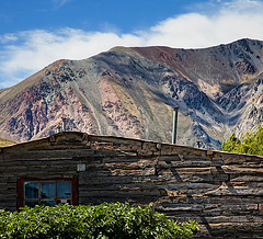 a blockhouse and colorful mountains