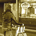 Cycliste en bottes à talons hauts / Walking Swedish biker in jeans & high-heeled boots at her cell phone - Ängelholm  / Suède - Sweden.  23-10-2008 - Sepia