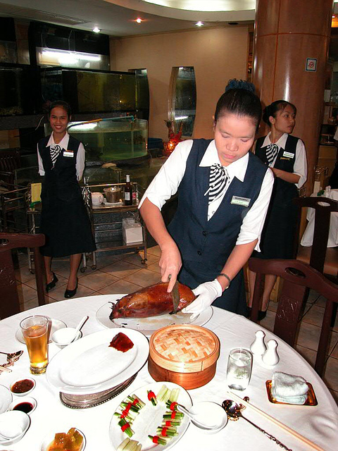 Serving Peking Duck in a Chinese Restaurant
