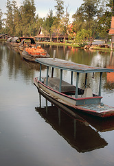 A tugboat pules the barges to the Floating Market