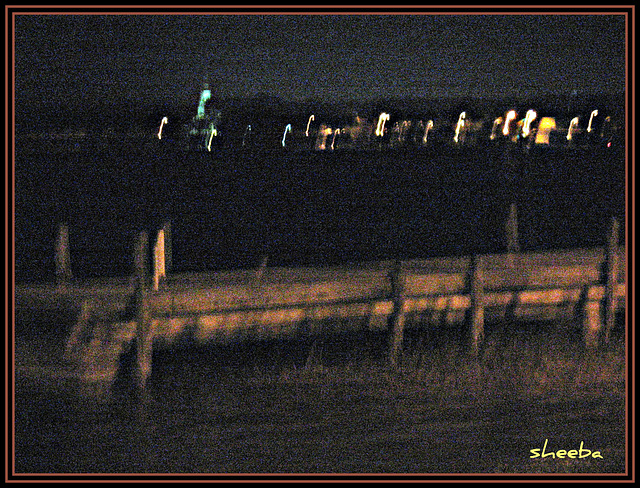 Lights reflect across lake..