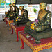 Statues sticked with gold plates in the Wat