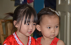 Two little girls in red