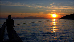 Fisherman under the sunset