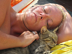 Mandi reclining with a Turkish cat sharing her sunbed