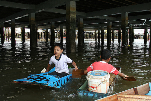 Boys in makeshift boats, Brunei.