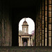 brompton cemetery, earls court,  london,designed in 1838 by benjamin baud, the arcades flanking the central path lead to a circus of similar arcades, with a circular chapel as the point de vue. there are catacombs below some of the arcades.