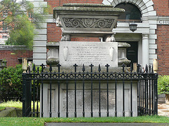 st.botolph bishopsgate, london,the 1838 tomb of william rawlins is in the graveyard of st.botolph bishopsgate next to the 1861 parish hall . sarcophagus with lion's paws.