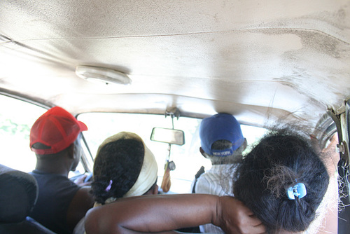 Three Adults Share the Front Seat in a Taxi