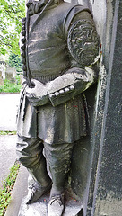 brompton cemetery, london,detail of one of the decapitated thames watermen, who wear doggett's coat and badge, from the tomb of champion oarsman robert coombes, 1808-60