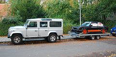 Land Rover with a race BMW on tow