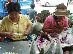 women threading garlands