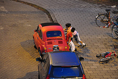Kids trying to push over a 1970 Fiat 500 L