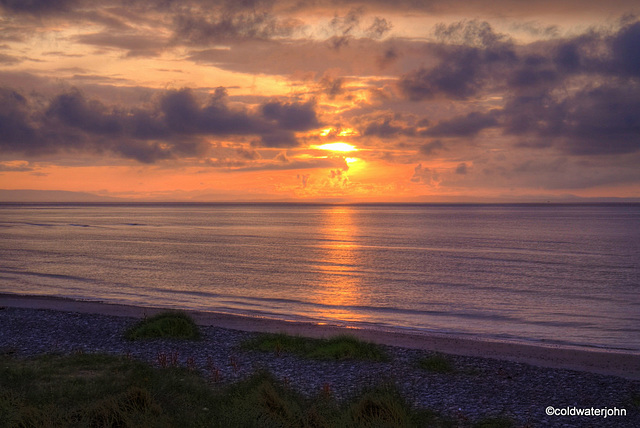 Findhorn Beach with a sun setting over the Moray Firth