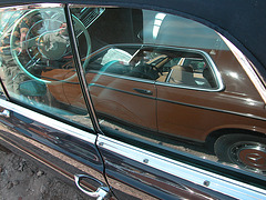 A Mercedes-Benz W123 Coupe reflected in a Mercedes-Benz 250 SE