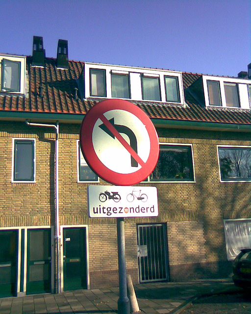 Old sign: no left turn (except for bicycles)