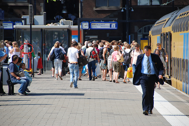 Celebration of the centenary of Haarlem Railway Station: passengers heading for the beach, train driver heading towards the other end of the train