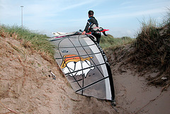 Dragging the wind-surfing board over the dunes