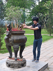 Lighting Incense in front of the Dai Hung Shrine at the Thien Mu Pagoda