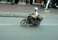 Old Motorbike Carrying a Big Gas Cylinder