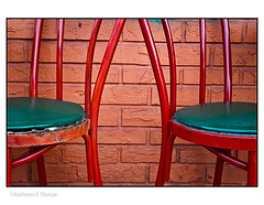 Red Chairs against brick wall