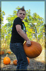 Mohawk Boy Holding Up Pumpkin